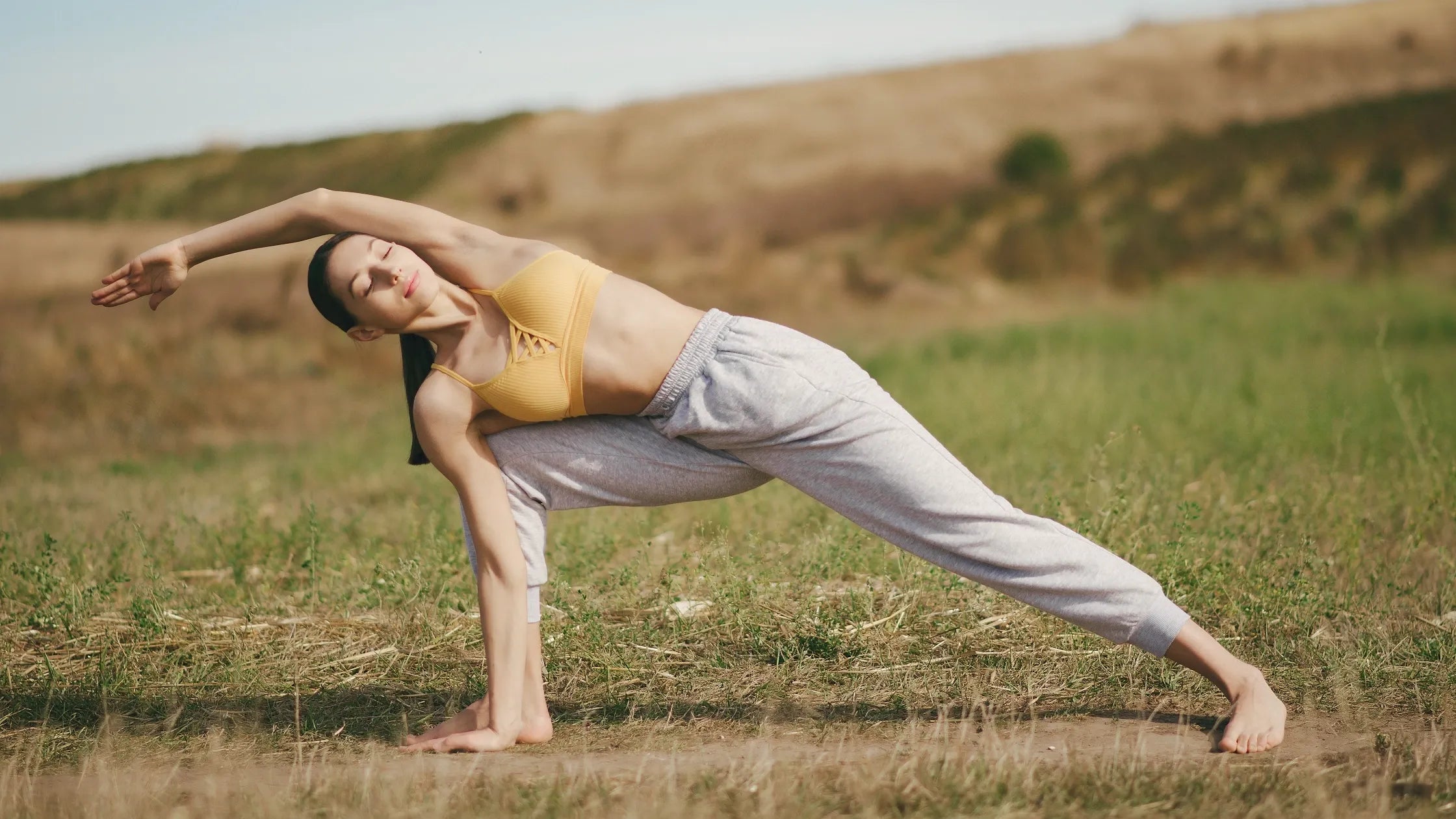 A person practicing yoga outdoors, promoting joint health and energy support from nature.