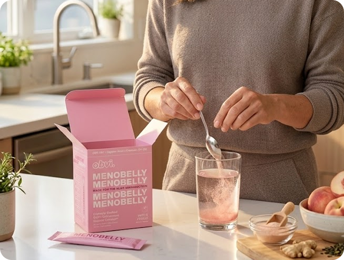 Woman mixing Menobelly powder into water in a kitchen