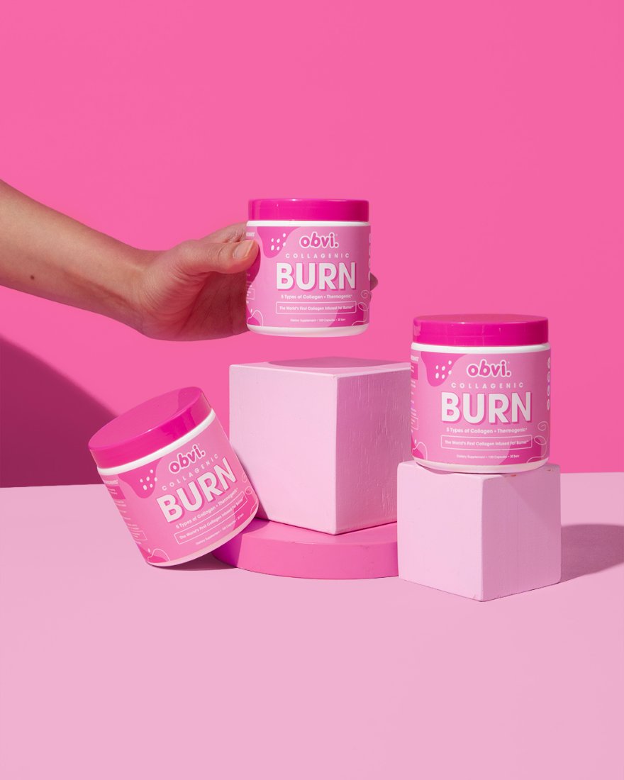 Three Collagenic Burn tubs styled on pink pedestals